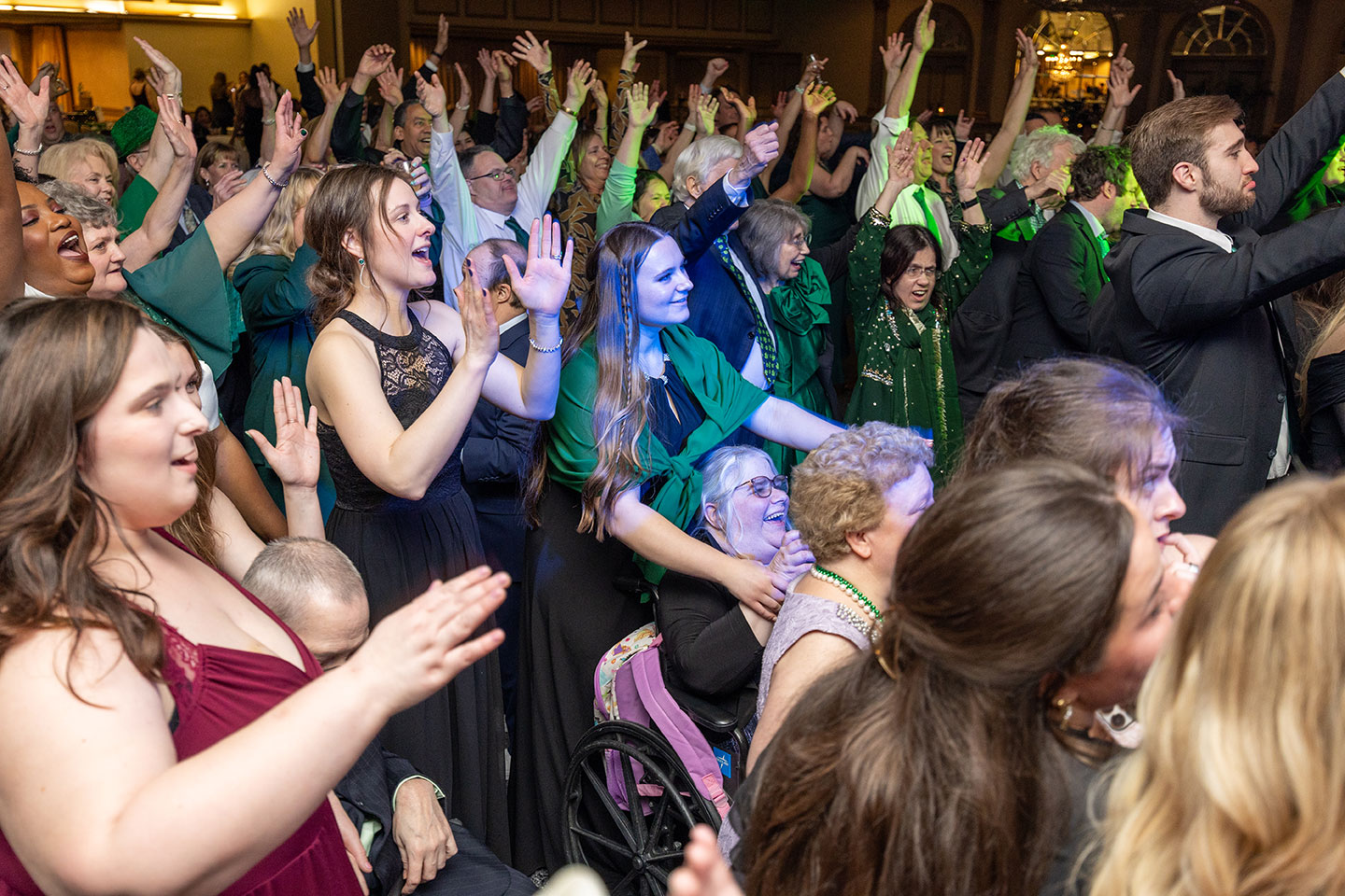 People dancing beneath a disco ball